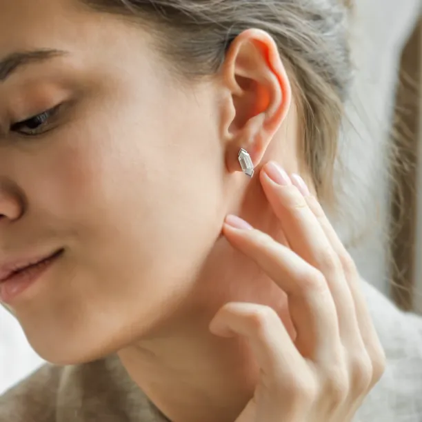 Close-up of a SERAPHINA moissanite earring worn on the ear