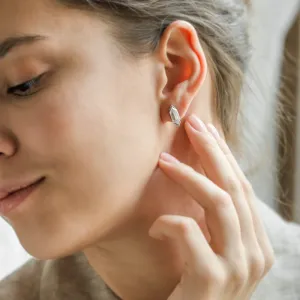 Close-up of a SERENA moissanite earring worn on the ear