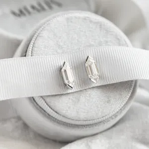 Pair of SERENA geometric moissanite earrings on a display cushion