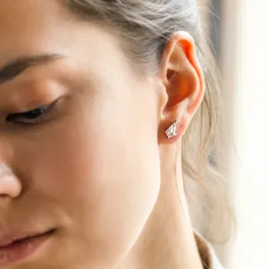Gold kite moissanite earring DANE worn on the ear, close-up