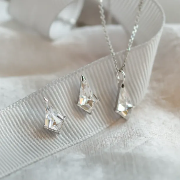 Angled close-up of DANE gold kite moissanite earrings