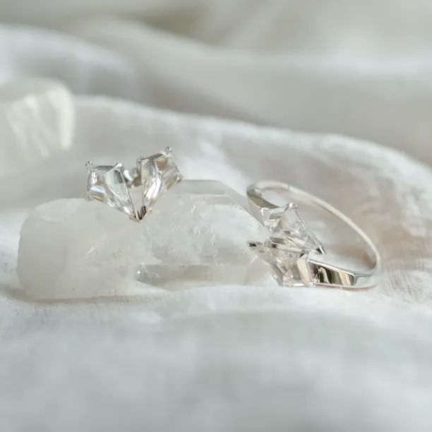 DANE gold kite moissanite earrings beside a matching ring