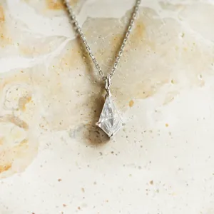 Close-up of the gold DIONA pendant with kite-shaped moissanite