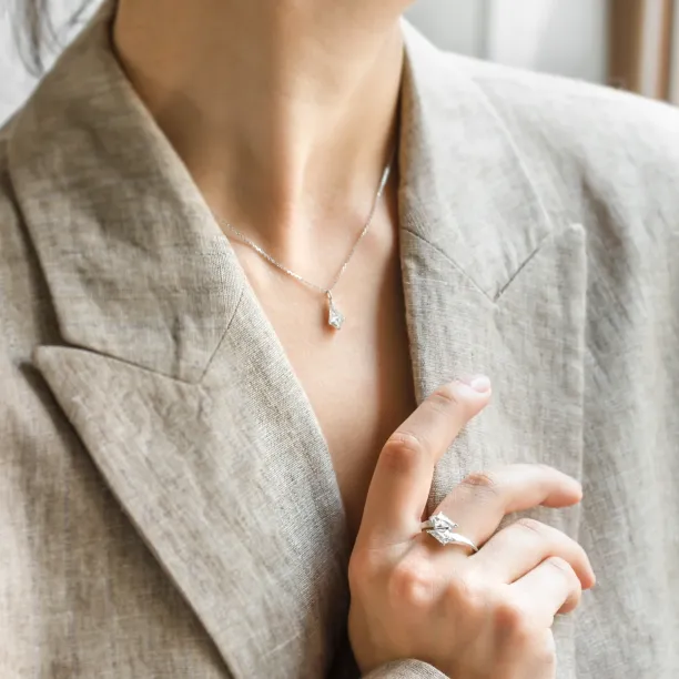 Gold DIONA pendant with kite-shaped moissanite worn on the neck