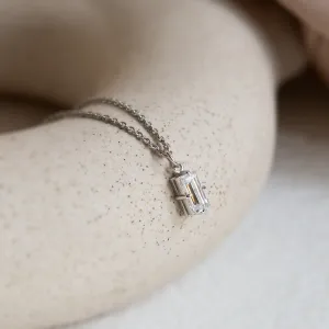 Detailní šikmý pohled na zlatý přívěsek s baguette laboratorním diamantem