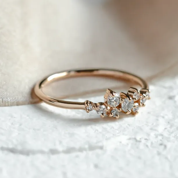 Close-up of the CLORÉ cluster ring with diamonds in a gold band