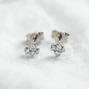 Close-up of the front of gold diamond cluster earrings
