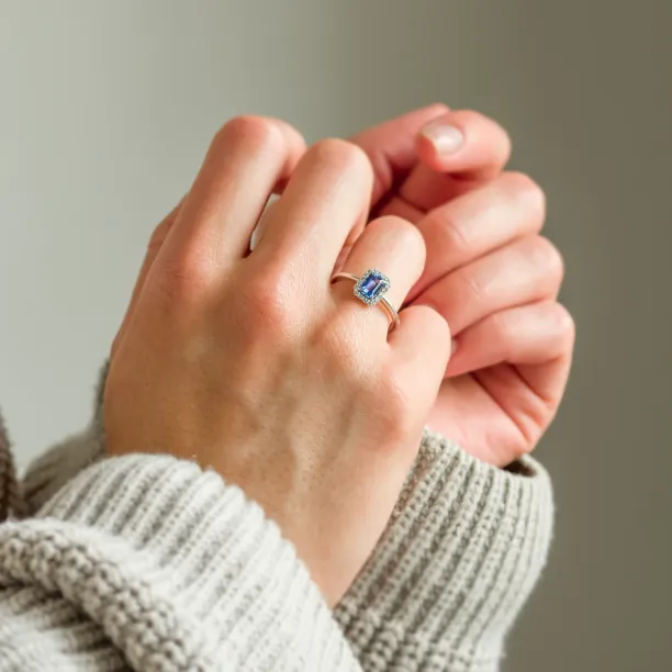 LEAR engagement ring with teal sapphire and diamonds worn on the hand