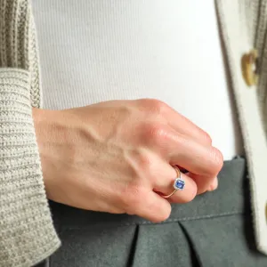 Angled view of LEAR engagement ring with teal sapphire and diamonds worn on the hand