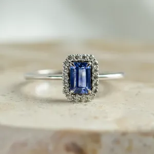 Close-up of LEAR engagement ring with baguette teal sapphire and diamonds