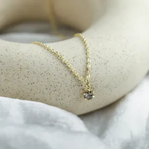 Close-up of the CADIE gold pendant and salt and pepper diamond