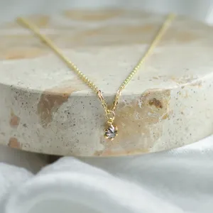 CADIE gold pendant with salt and pepper diamond in a centered close-up