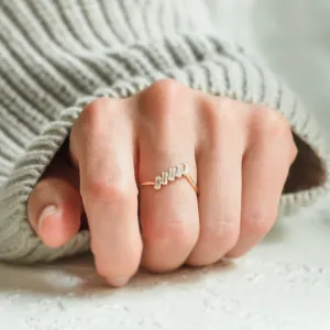 FRANCES gold ring with five baguette moissanites worn on a hand