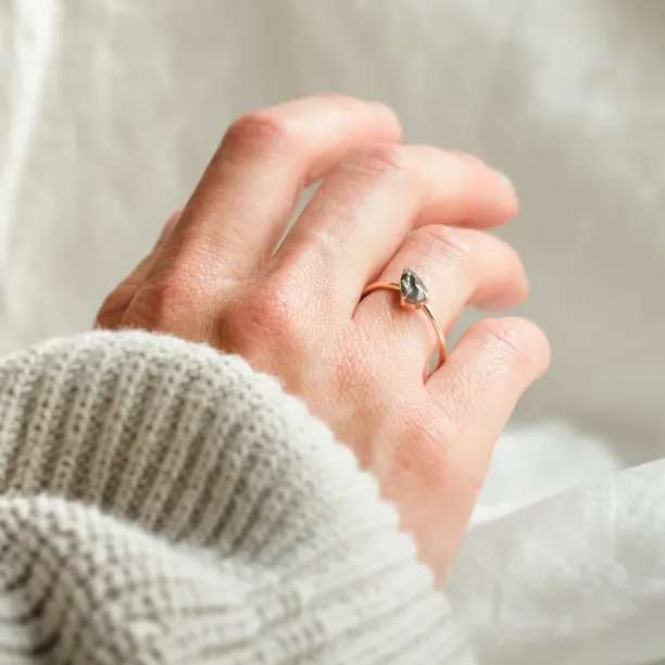 ALIA pear-shaped salt and pepper engagement ring worn on the hand