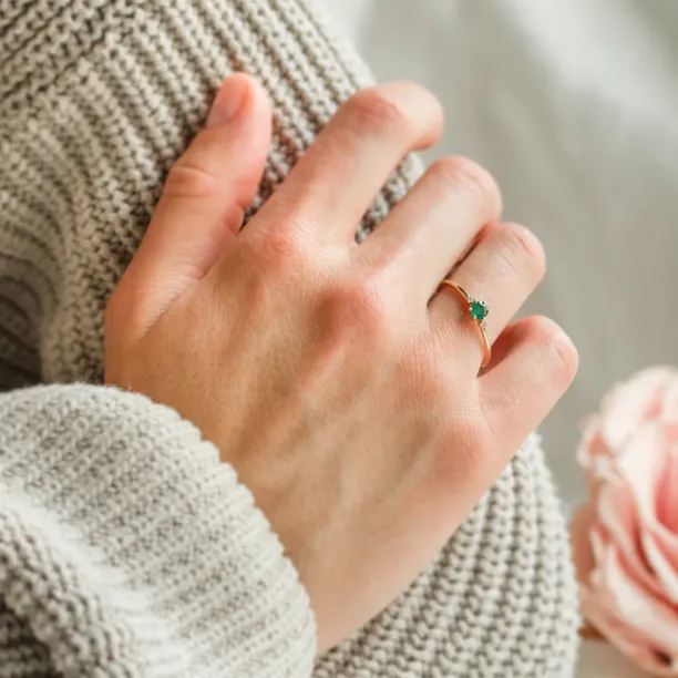 Engagement ring with emerald and side diamonds AVA Image