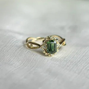 BAROQUE vintage gold ring with green sapphire and diamonds, angled close-up