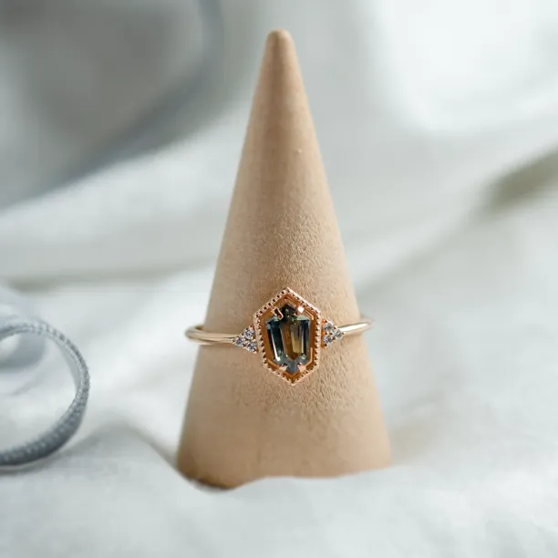 Gold vintage ring with a hexagon sapphire and diamond accents on display