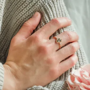 Gold vintage ring with a hexagon sapphire and diamonds worn on a hand