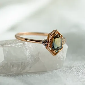 Angled close-up of the gold ring with a hexagon sapphire and diamonds