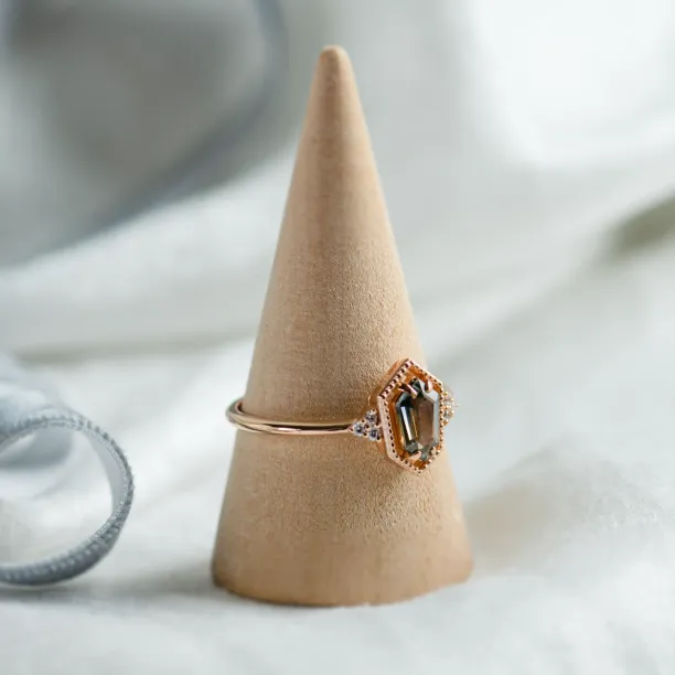 Angled view of the gold vintage MAISY ring with a hexagon sapphire and diamonds