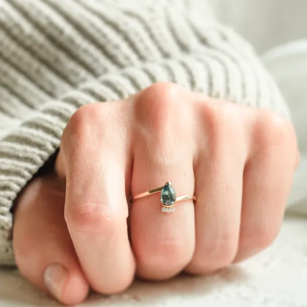 LEAH ring with a pear-shaped teal sapphire and diamonds worn on the hand