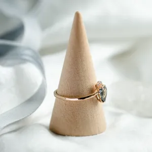 Side view of the LEAH gold ring with a teal sapphire and diamonds
