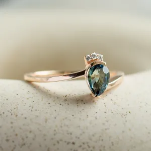 Close-up of the LEAH ring with a pear-shaped teal sapphire and diamonds