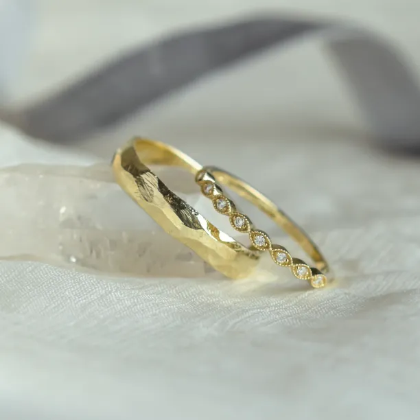 Angled view of yellow gold DARLING diamond wedding bands