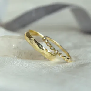 Angled view of yellow gold DARLING diamond wedding bands