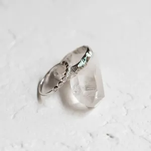Angled view of DARLING diamond wedding bands with textured detailing