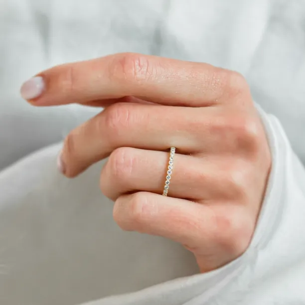 Diamond eternity wedding ring worn on a hand