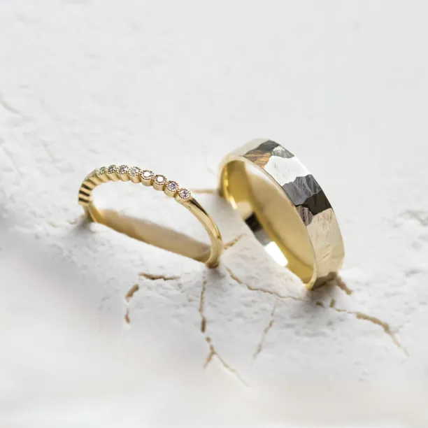 Angled view of the diamond eternity ring and hammered wedding band