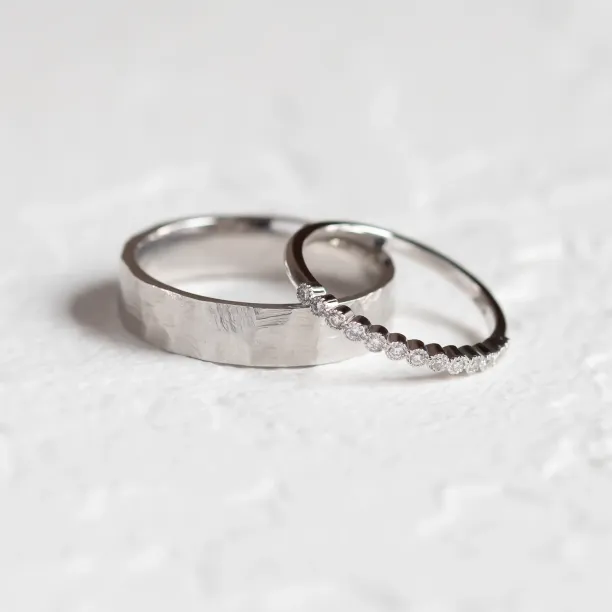 PAIR diamond wedding rings, showing a hammered band and diamond eternity ring