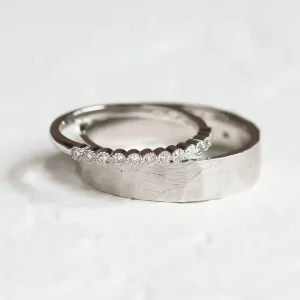 Close-up of the PAIR wedding rings with diamonds and hammered surface