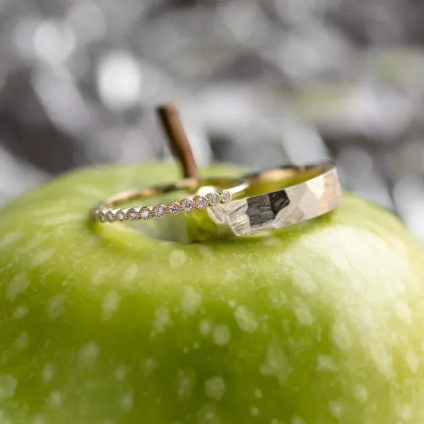 Angled view of the PAIR wedding rings with diamonds