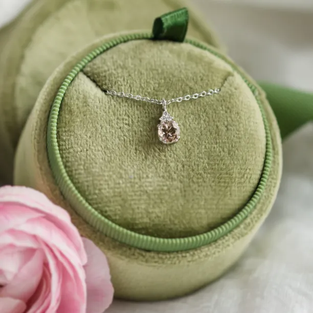 Close-up of FEMINA gold necklace with morganite pendant and side diamonds