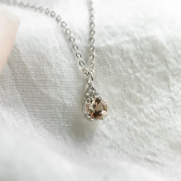 Close-up of morganite pendant and side diamonds on FEMINA gold necklace