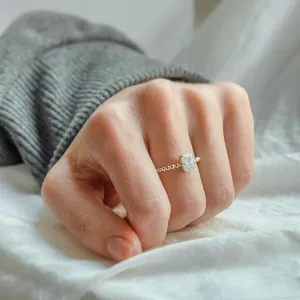 CLEA beaded engagement ring with radiant moissanite worn on a hand