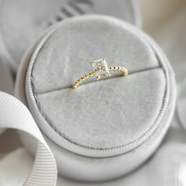 Angled view of the CLEA beaded ring with radiant moissanite