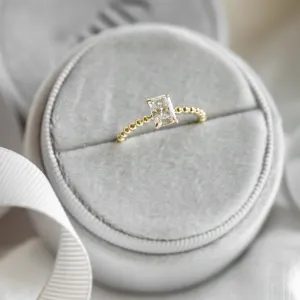 Angled view of the CLEA beaded ring with radiant moissanite