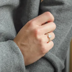 Close-up of the CLEA radiant moissanite ring worn on the hand