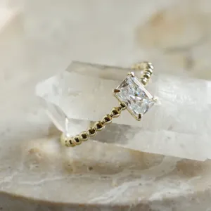 Close-up detail of the CLEA beaded ring and radiant moissanite