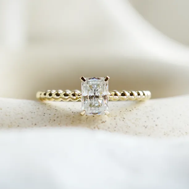 CLEA beaded engagement ring with a radiant moissanite