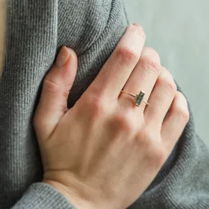 Close-up of the BRONTE engagement ring with baguette moss agate worn on the hand