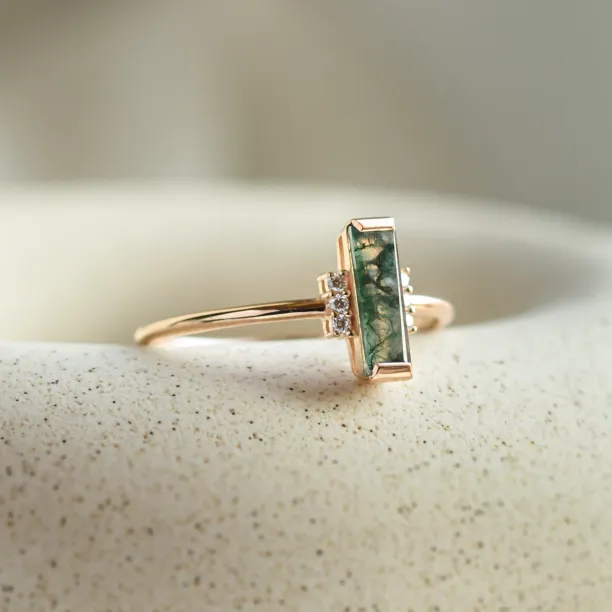 Angled view of the BRONTE ring with baguette moss agate and diamonds