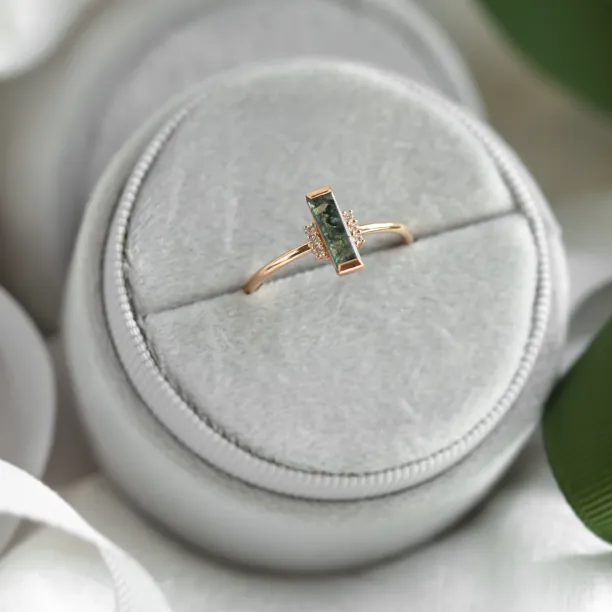 Angled view of the BRONTE engagement ring with baguette moss agate and diamonds