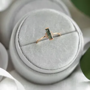 Angled view of the BRONTE engagement ring with baguette moss agate and diamonds