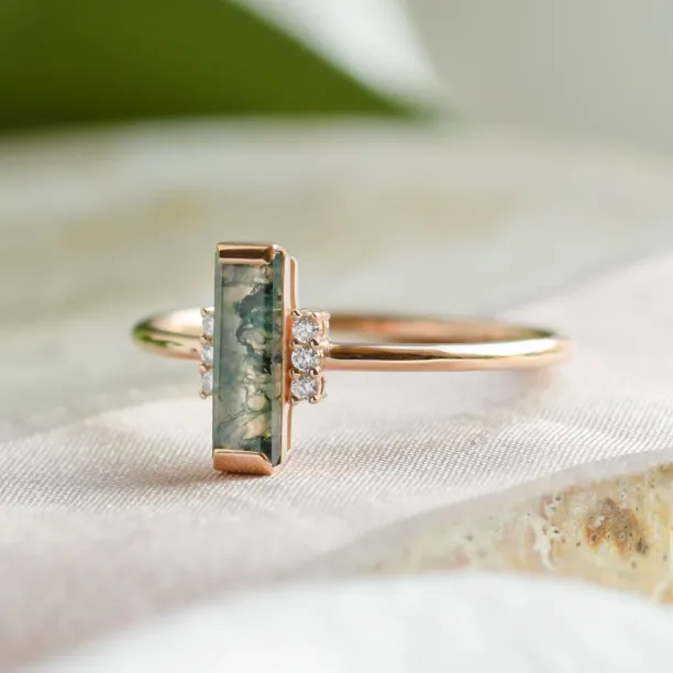 Side view of the BRONTE ring with baguette moss agate and diamonds