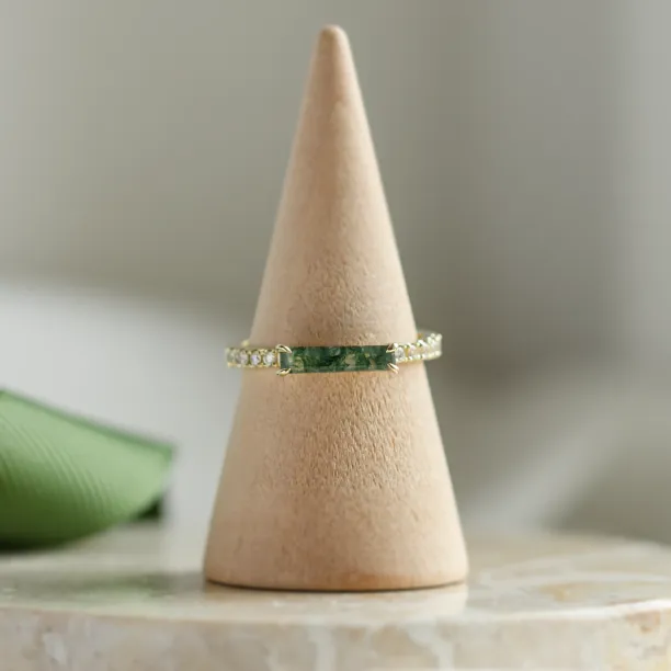 MILA engagement ring with a central baguette moss agate and side diamonds