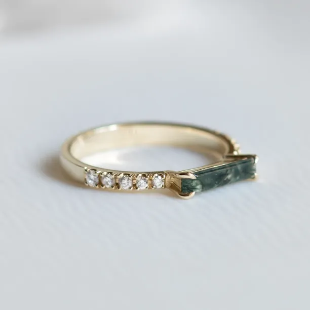 Close-up angled view of the MILA moss agate and diamond engagement ring